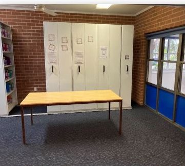 Same classroom after cleaning — spotless carpet and tidy shelves