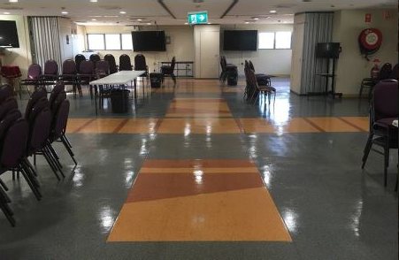 Church hall with gleaming floors and arranged chairs